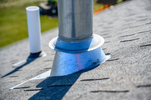 galvanized metal chimney exhaust with boot on asphalt roof